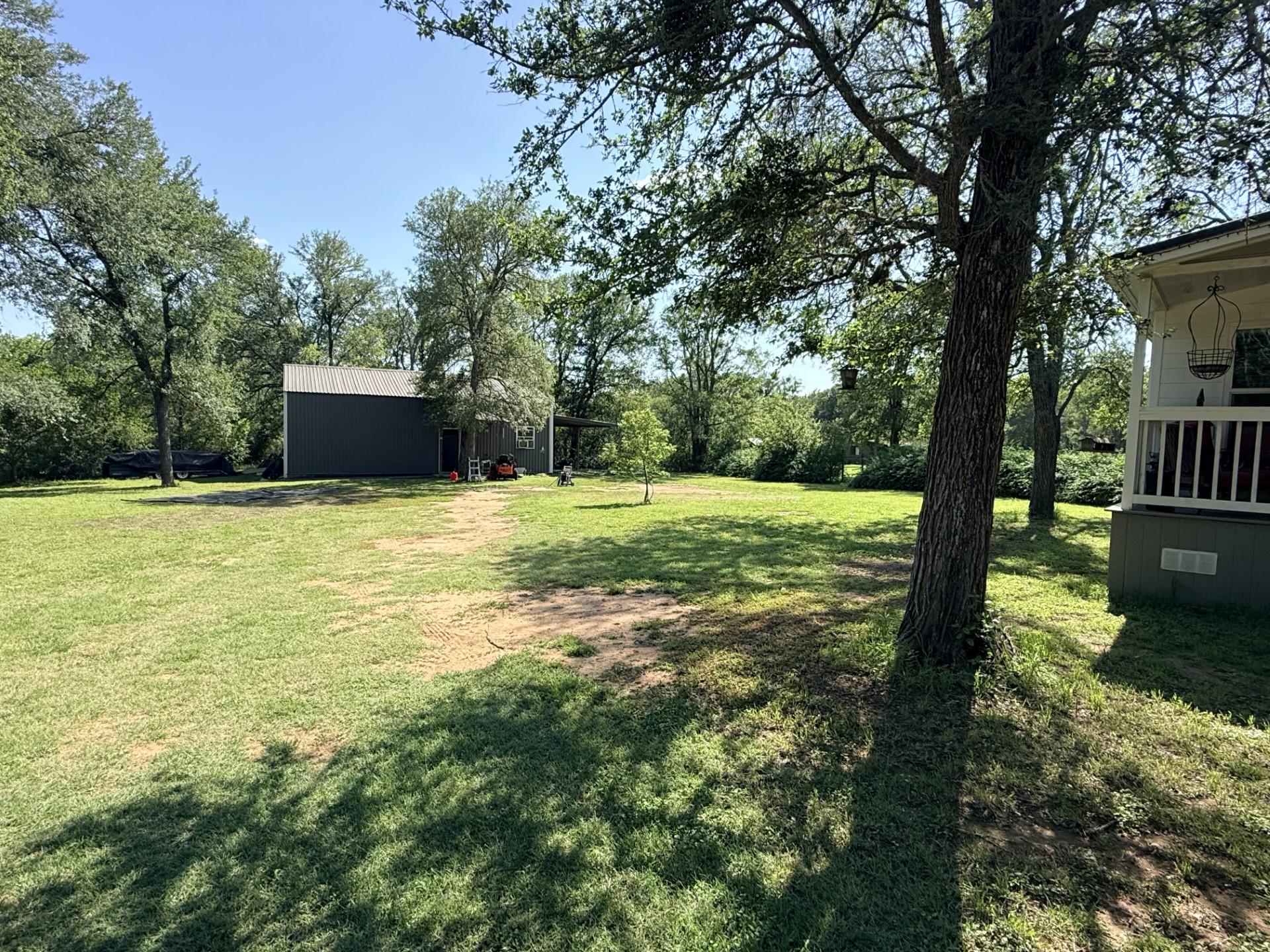 227 Crooked Hollow Road Elgin, TX 78621 - Photo 2 of 11 a backyard of a house with lots of green space