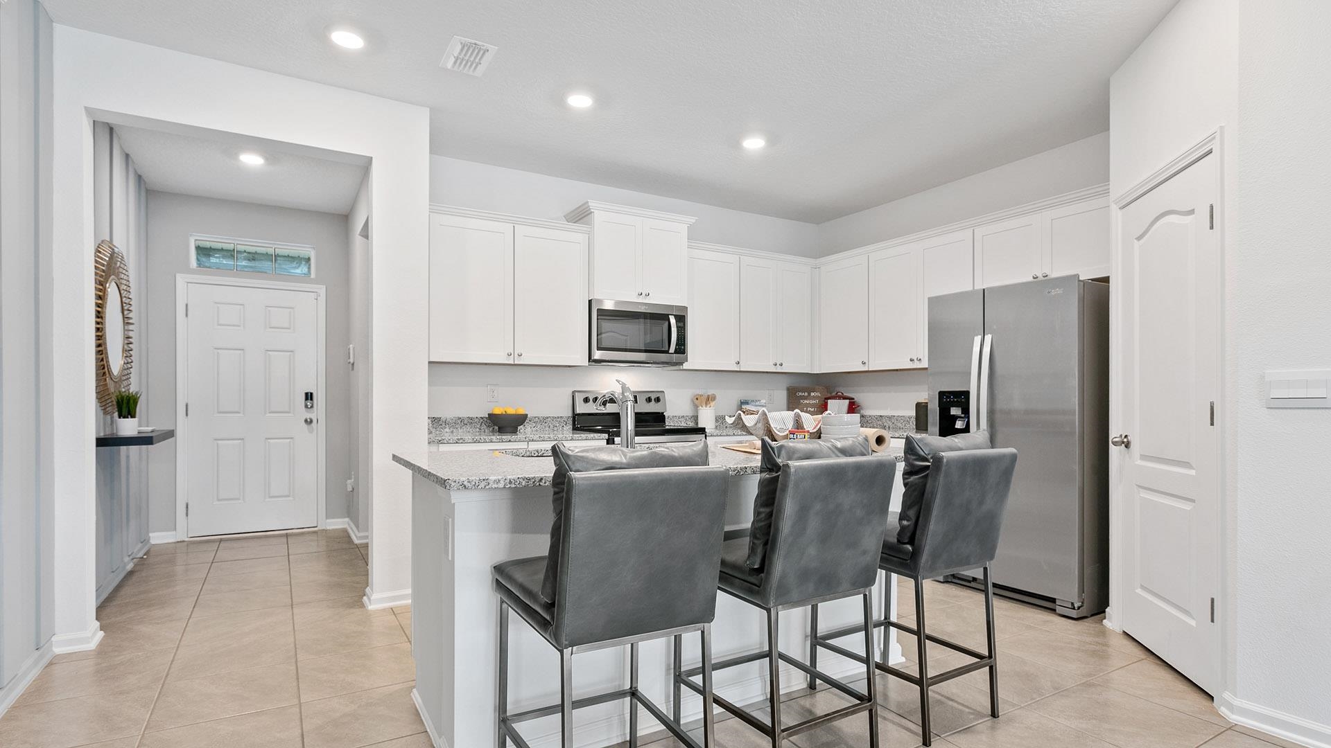 296 Redbud Road Palm Coast, FL 32137 - Photo 7 of 33 a kitchen with refrigerator and cabinets