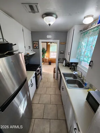 a kitchen with a sink appliances and cabinets
