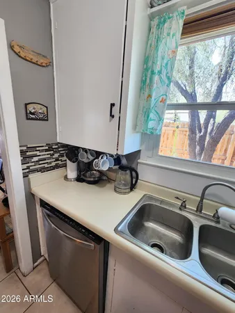 a kitchen with a sink cabinets and window