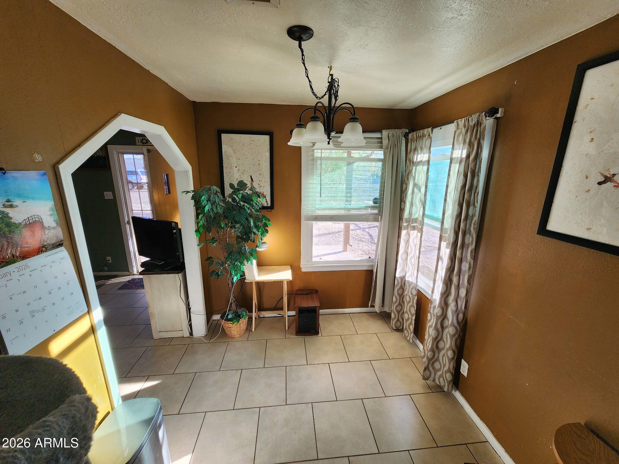 240 West 3rd Avenue Ajo, AZ 85321 - Photo 9 of 25 a living room with furniture and a flat screen tv