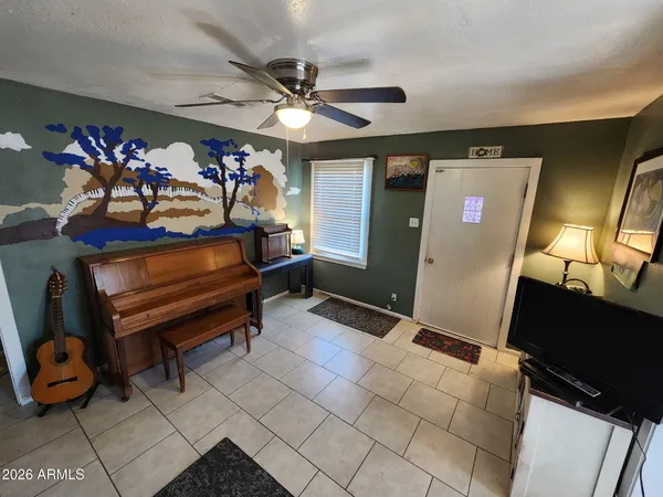 a bedroom with furniture and a mirror