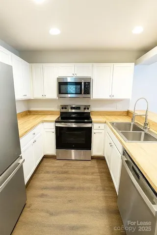 a kitchen with a stove a sink and a microwave