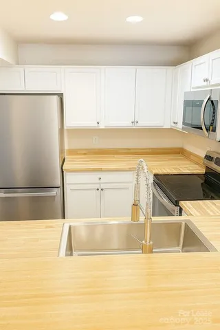 a view of a kitchen with wooden floor and a sink