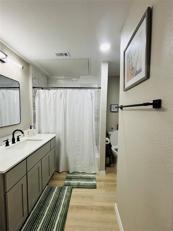 14277 Preston Road, Unit 416 Dallas, TX 75254 - Photo 28 of 40 Vanity with gray cabinetry, white countertop, and black fixtures