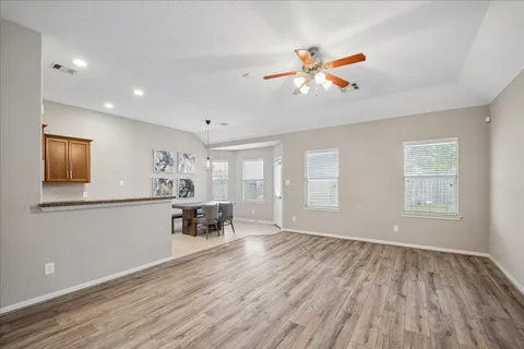 a view of a room with furniture and wooden floor