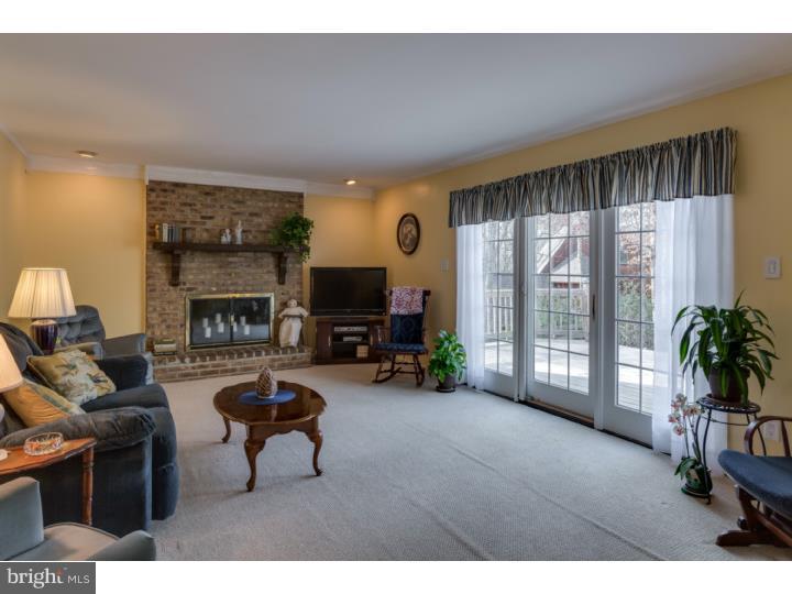 21 Fairview Road Medford, NJ 08055 - Photo 11 of 25 a living room with furniture a fireplace a large window and a flat screen tv