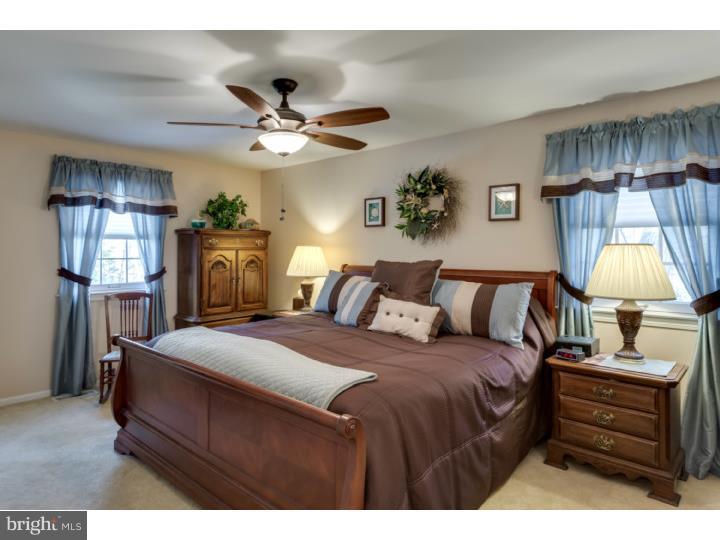 21 Fairview Road Medford, NJ 08055 - Photo 14 of 25 a bed room with a bed mirror and a lamp