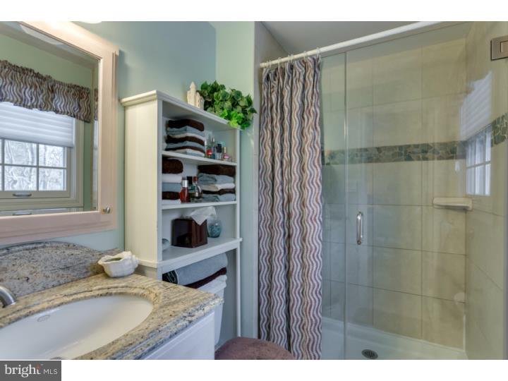 21 Fairview Road Medford, NJ 08055 - Photo 15 of 25 a bathroom with a granite countertop sink a vanity and a shower