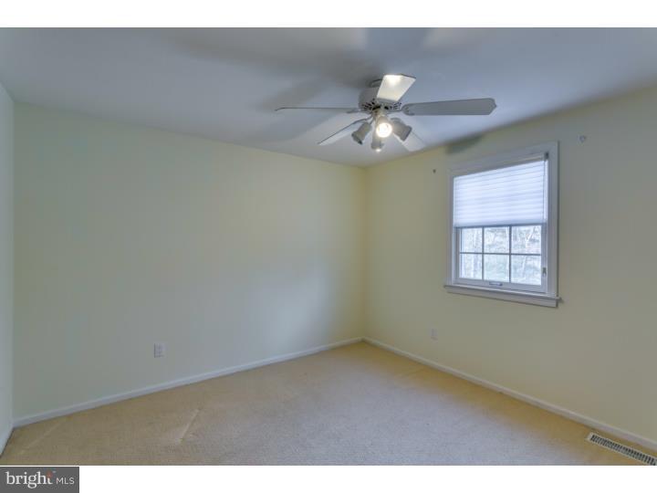 21 Fairview Road Medford, NJ 08055 - Photo 16 of 25 a view of an empty room with a ceiling fan and window