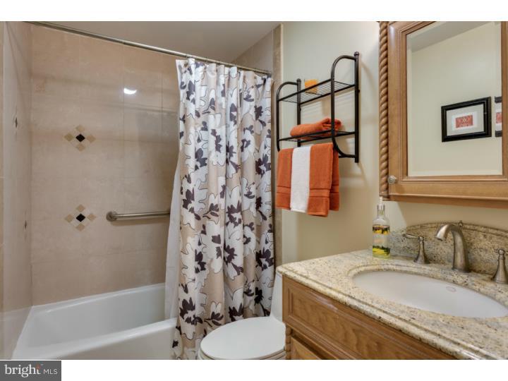 21 Fairview Road Medford, NJ 08055 - Photo 17 of 25 a bathroom with a granite countertop sink a mirror a shower and a bathtub