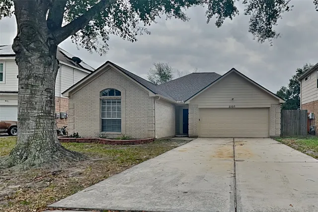 a view of a house with a yard and garage