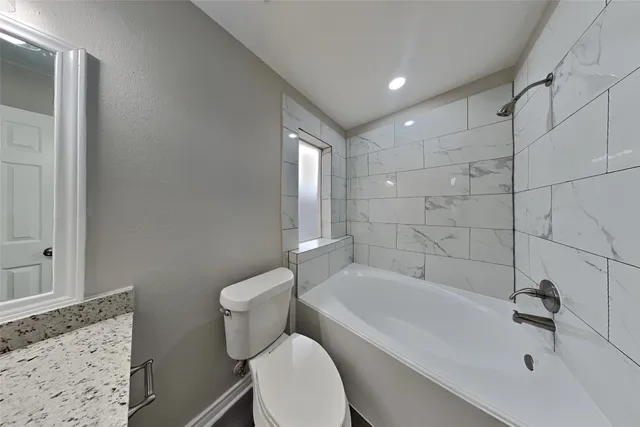 a bathroom with a bathtub and toilet