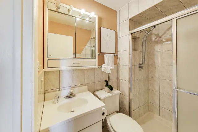 a bathroom with a sink toilet and shower