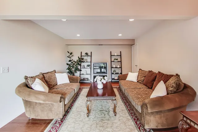 a living room with furniture and wooden floor