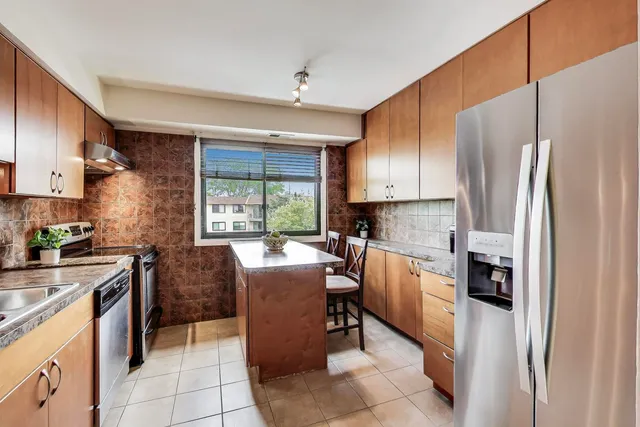 a kitchen with a refrigerator a stove top oven a sink dishwasher and a refrigerator