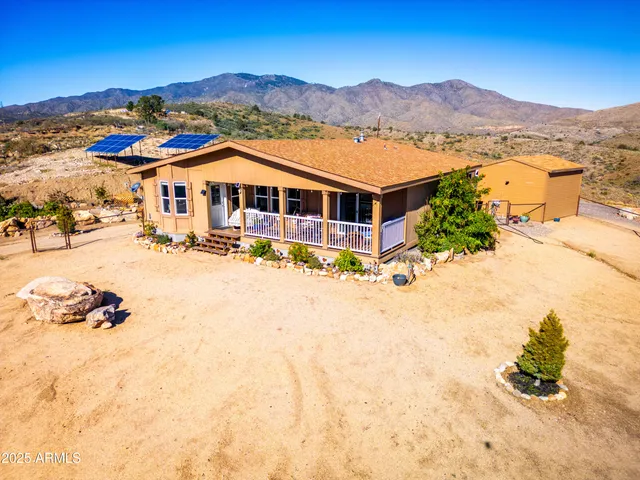 a front view of a house with a yard covered in snow