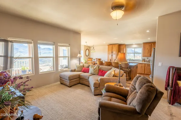 a living room with furniture fireplace and a large window
