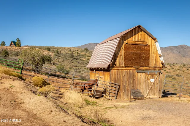 a view of a yard with a wooden wall