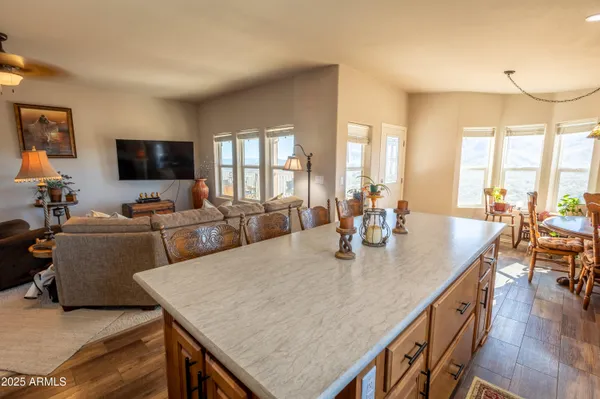 a kitchen with stainless steel appliances granite countertop a refrigerator stove top oven and sink