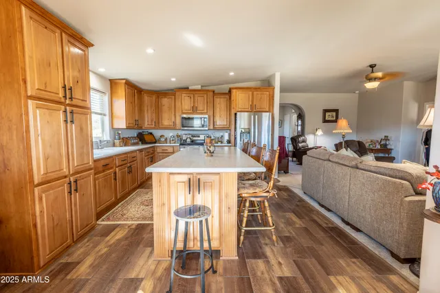 a kitchen with stainless steel appliances granite countertop a sink stove and cabinets