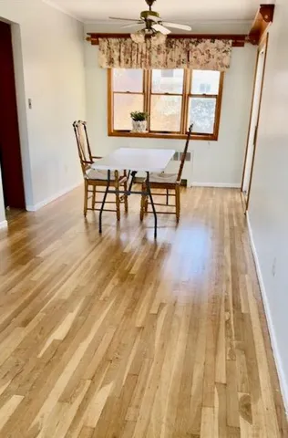 a dining room with wooden floor and a table