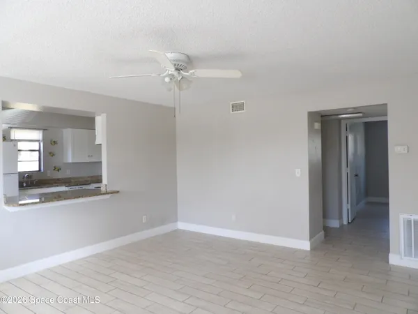 a view of a room with wooden floor and closet