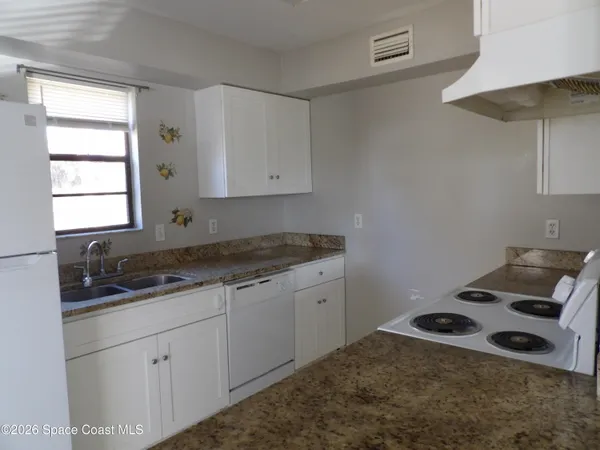 a kitchen with a stove and a cabinets