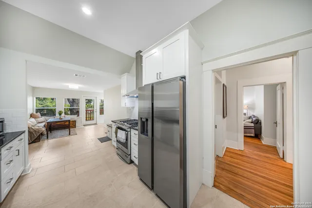 a kitchen with a refrigerator and a sink