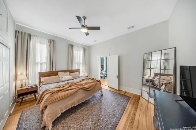 a bedroom with a bed and a chandelier