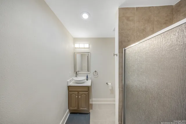 a bathroom with a sink and mirror