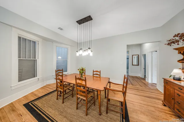 a view of a dining room with furniture wooden floor and chandelier