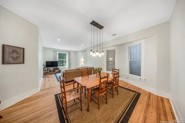 a view of a dining room with furniture window and wooden floor