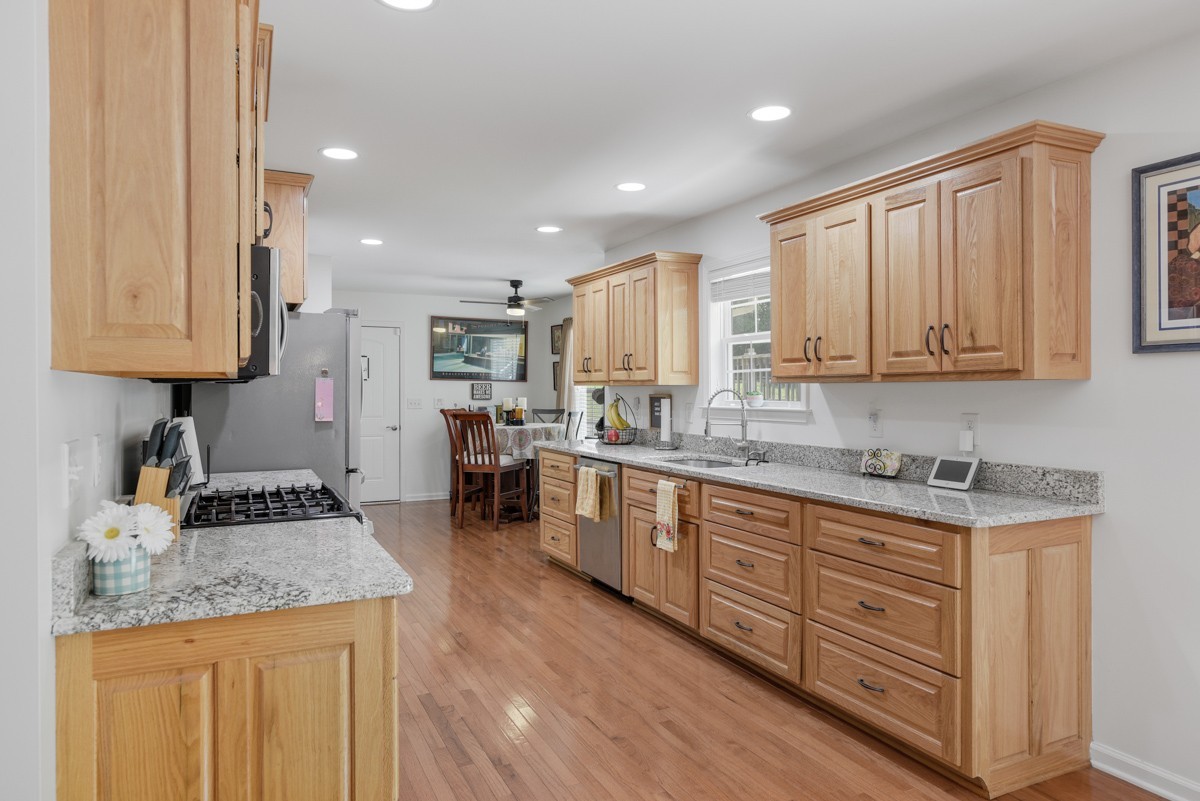 1555 Heller Ridge Spring Hill, TN 37174 - Photo 13 of 50 a kitchen with stainless steel appliances granite countertop a stove a sink and a refrigerator