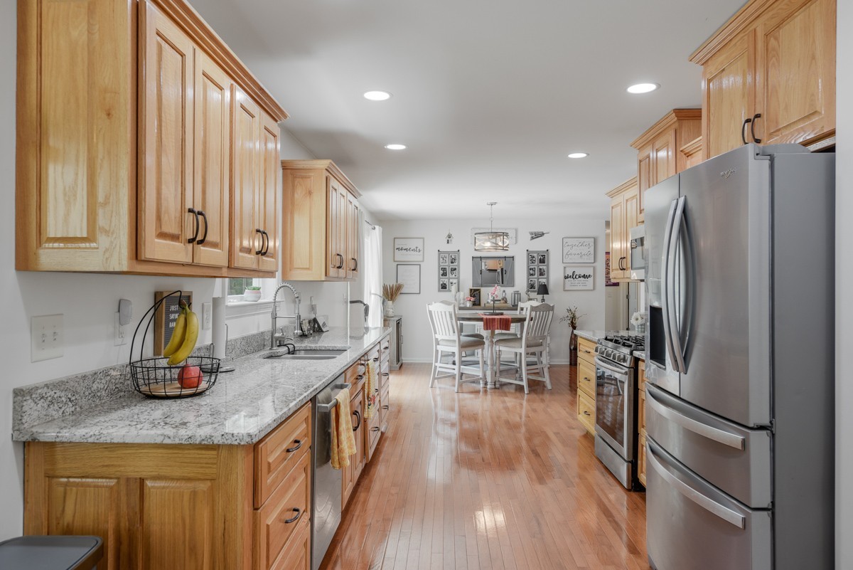 1555 Heller Ridge Spring Hill, TN 37174 - Photo 15 of 50 a kitchen with granite countertop a refrigerator stove and sink