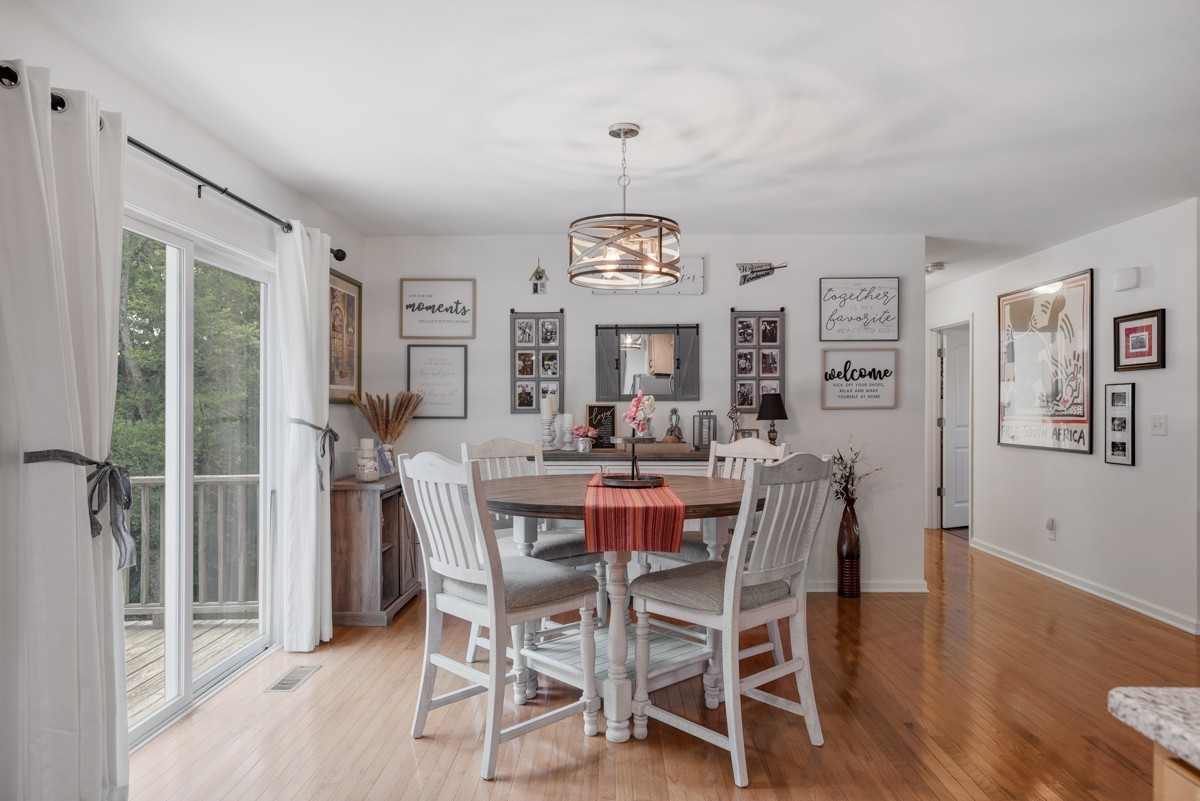 1555 Heller Ridge Spring Hill, TN 37174 - Photo 17 of 50 a view of a dining room with furniture window and wooden floor