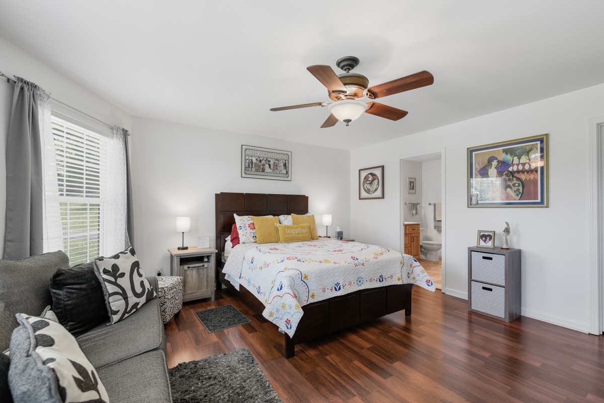 1555 Heller Ridge Spring Hill, TN 37174 - Photo 23 of 50 a bedroom with a bed a couch and a window