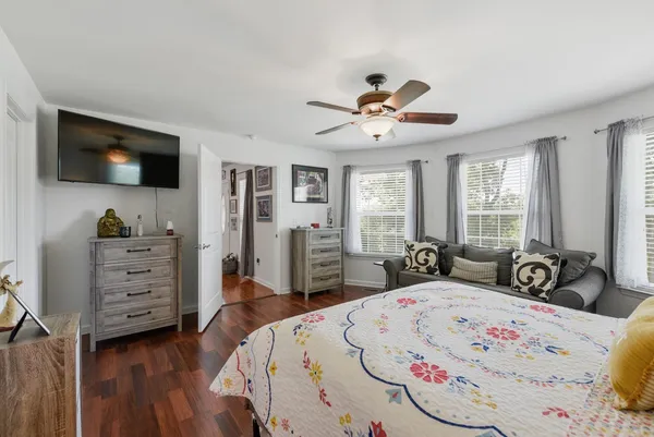 a view of a bedroom with furniture and windows