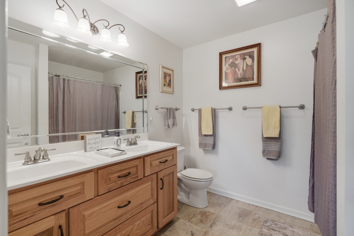 1555 Heller Ridge Spring Hill, TN 37174 - Photo 25 of 50 a spacious bathroom with a granite countertop toilet sink and mirror