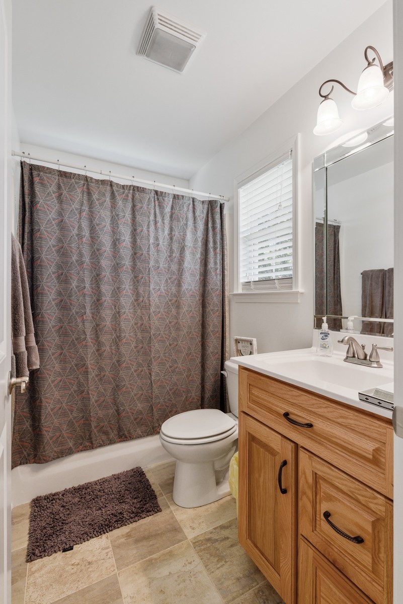 1555 Heller Ridge Spring Hill, TN 37174 - Photo 27 of 50 a bathroom with a granite countertop sink toilet and a mirror