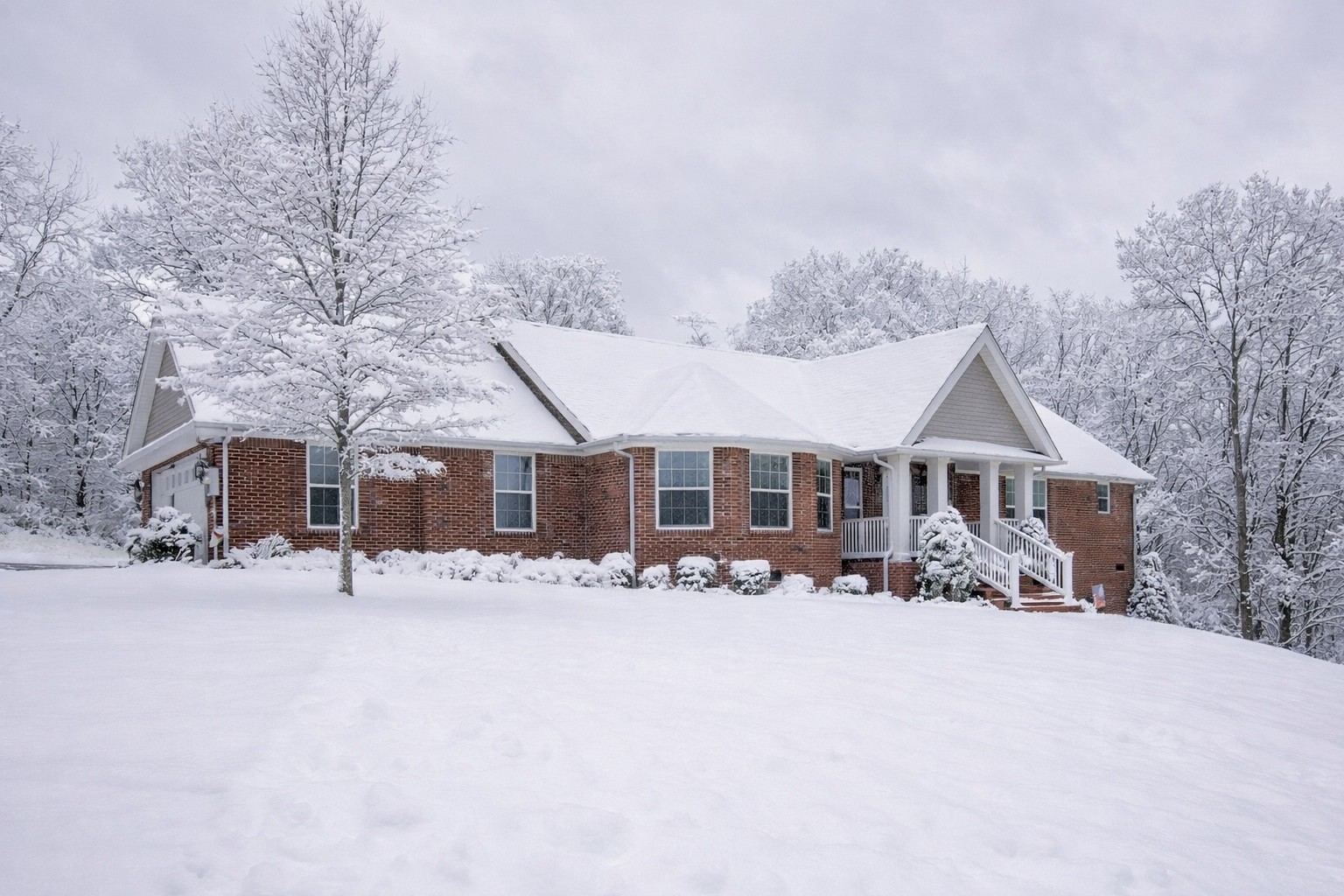 1555 Heller Ridge Spring Hill, TN 37174 - Photo 4 of 50 a front view of a house with a yard covered in snow