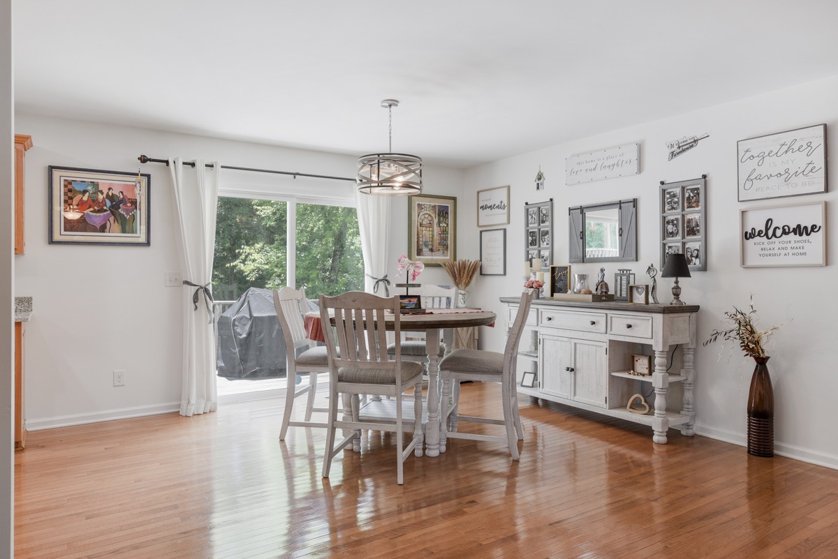 1555 Heller Ridge Spring Hill, TN 37174 - Photo 9 of 50 a view of a dining room with furniture window and wooden floor