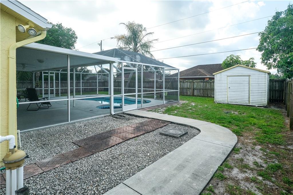 842 Southwest Commonwealth Road Port St. Lucie, FL 34953 - Photo 34 of 36 a view of a backyard with a plants and large tree