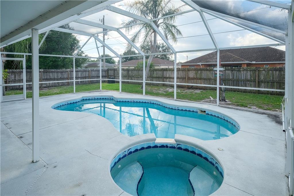 842 Southwest Commonwealth Road Port St. Lucie, FL 34953 - Photo 7 of 36 a view of a backyard with swimming pool