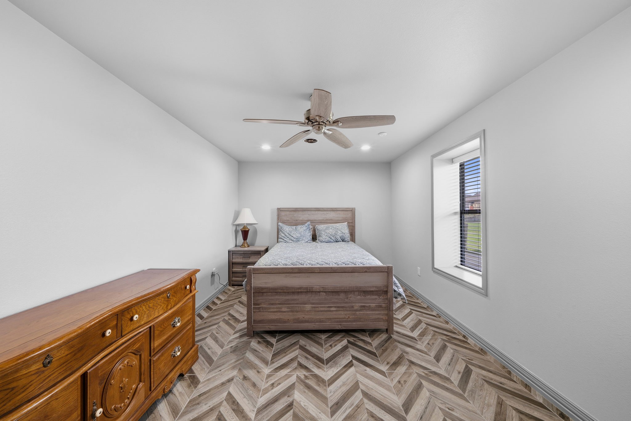 21620 Schiel Road Cypress, TX 77433 - Photo 35 of 49 Bedroom in the barn apartment. The apartment has low maintenance tile floors laid in a herringbone pattern throughout.