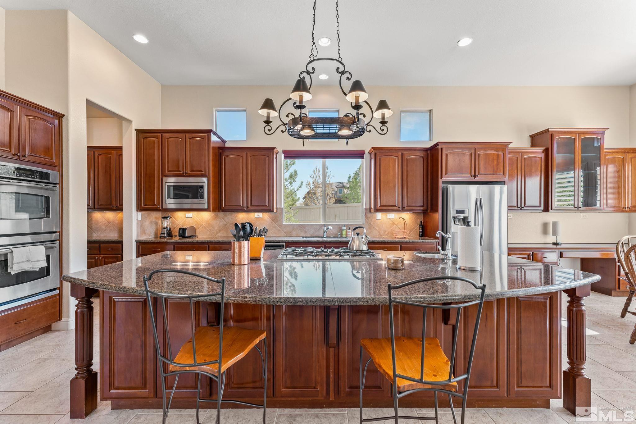 13395 Damonte View Lane Reno, NV 89511 - Photo 12 of 40 a very nice looking kitchen with granite countertop a stove and cabinets