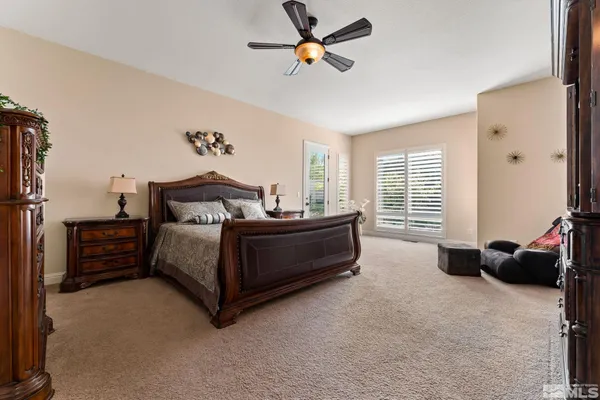 a bedroom with a bed a flat screen tv and a couch