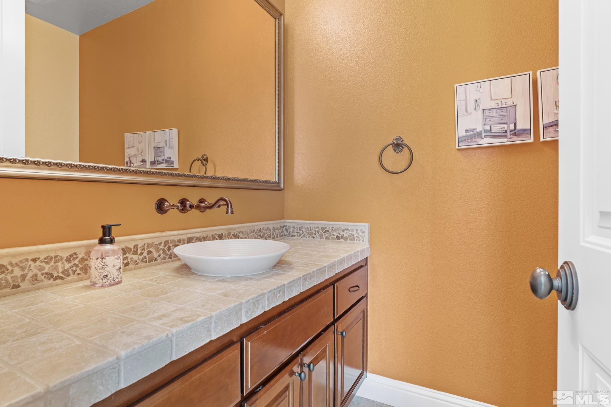 13395 Damonte View Lane Reno, NV 89511 - Photo 29 of 40 a bathroom with a granite countertop sink and a mirror