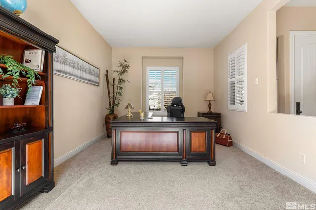 a view of a workspace with furniture and a potted plant