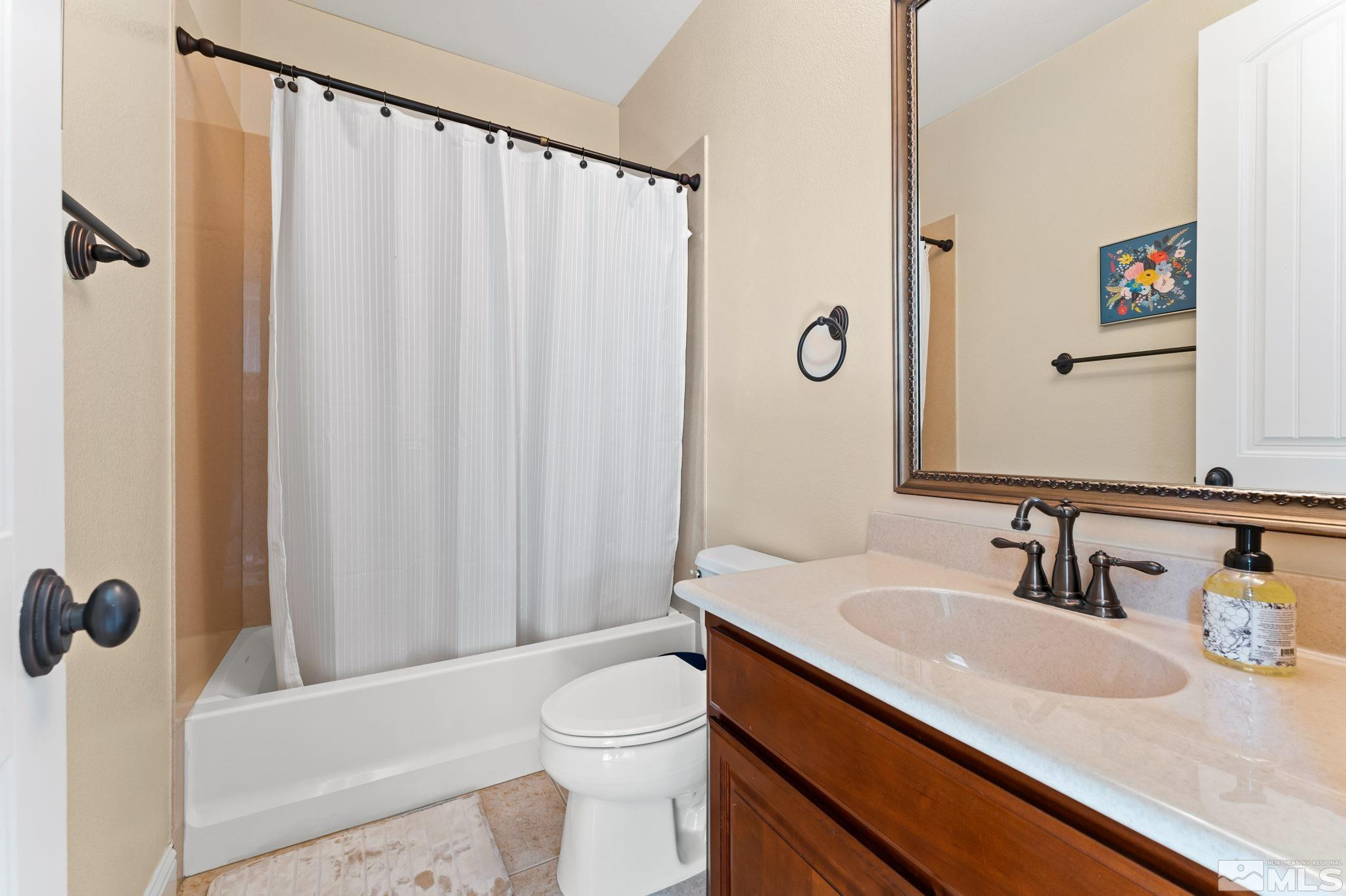 13395 Damonte View Lane Reno, NV 89511 - Photo 34 of 40 a bathroom with a sink a toilet and shower curtain